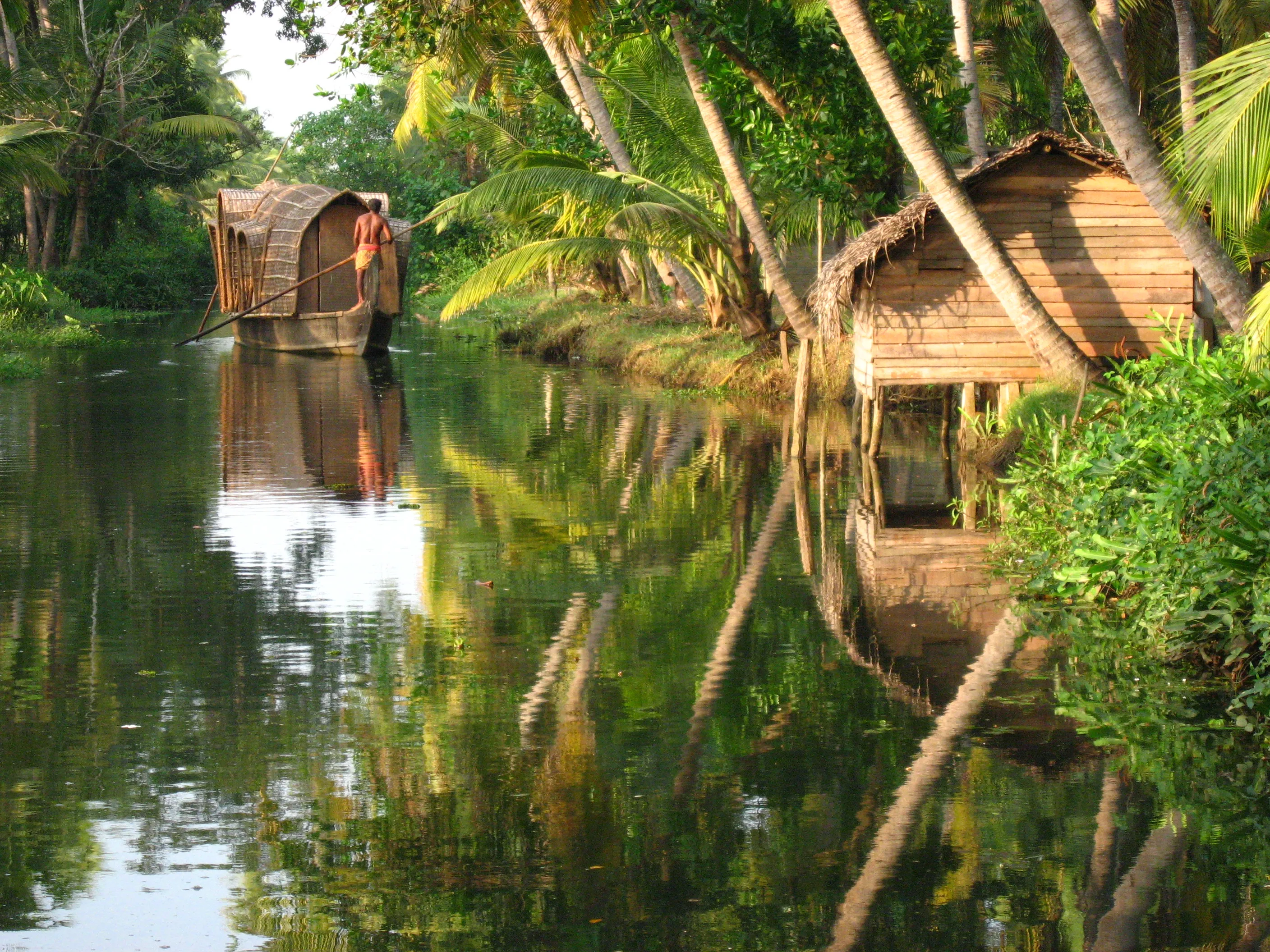 A CeePee houseboat cruising the palm-fringed Alleppey backwaters