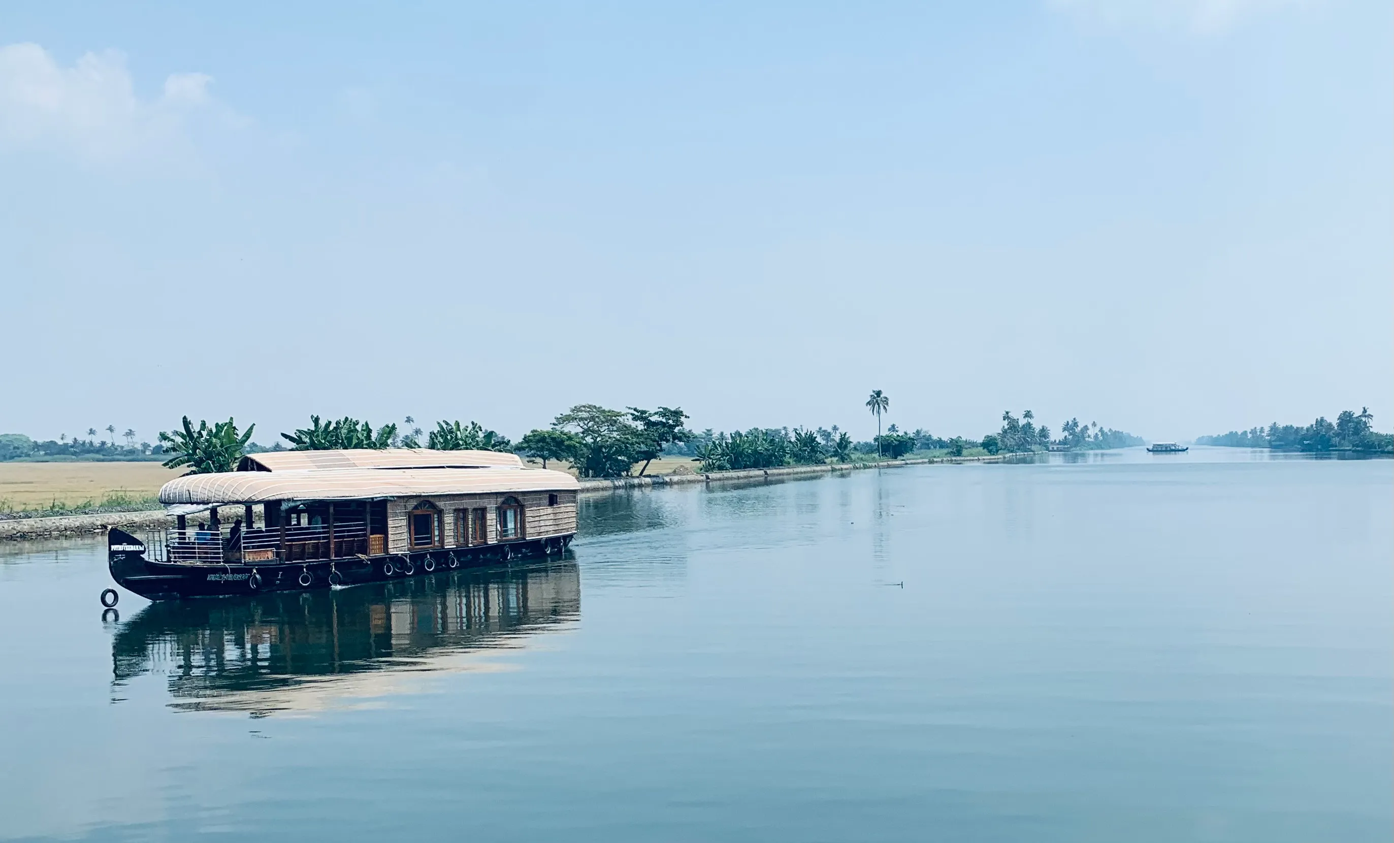 A CeePee houseboat lit up on the backwaters after nightfall