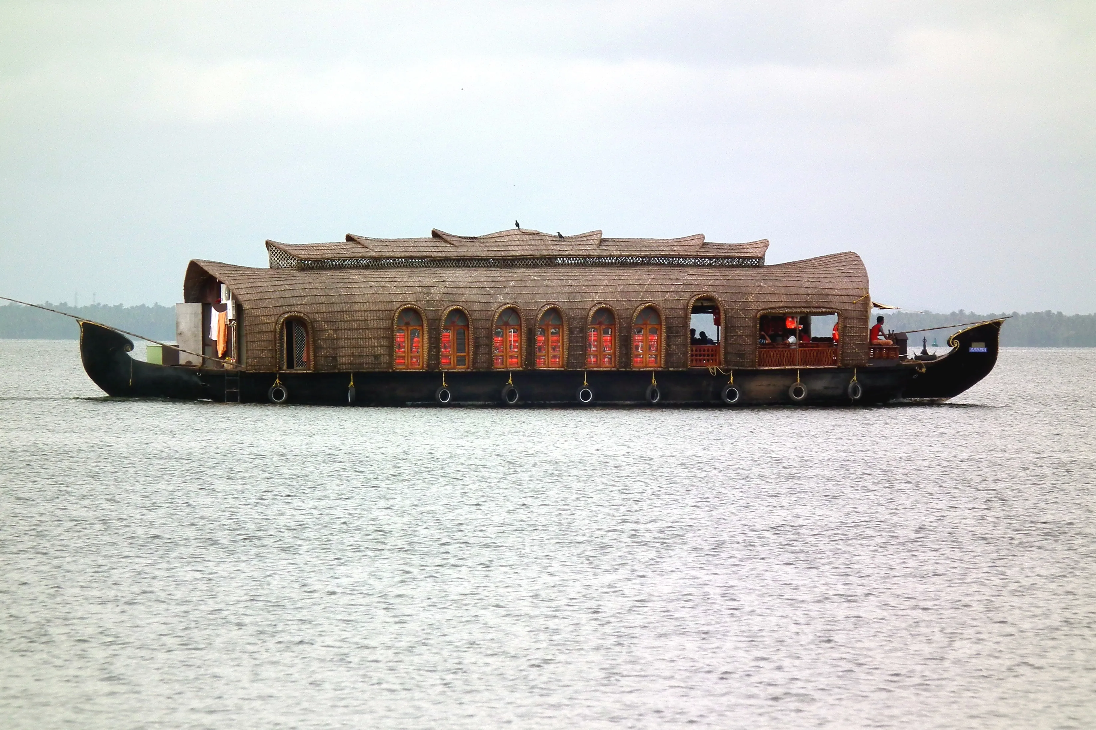 A fleet of CeePee houseboats moored along the Alleppey backwaters, Kerala