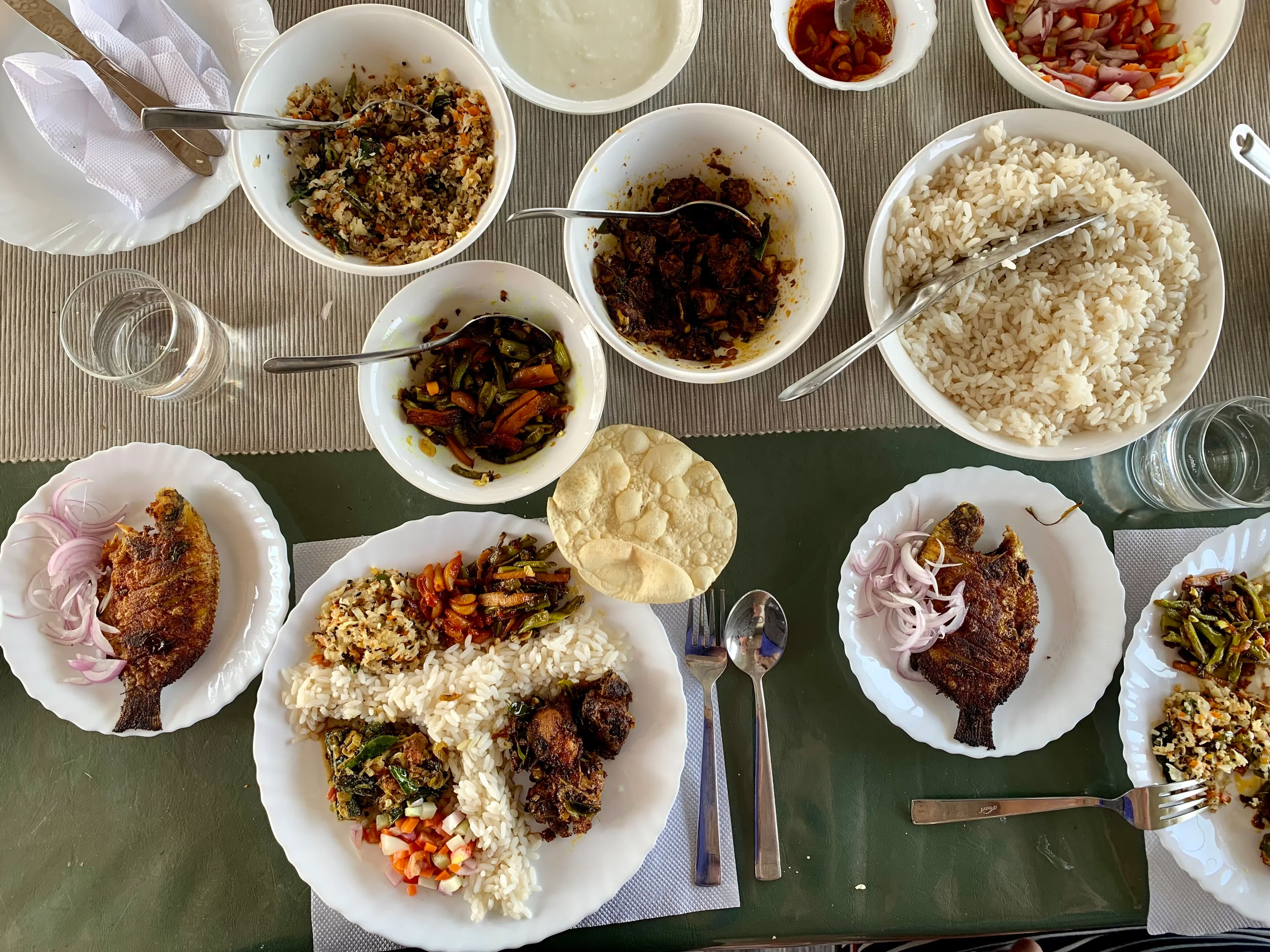 A Kerala meal and welcome drinks laid out on a CeePee houseboat dining table